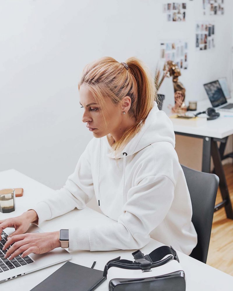 beautiful-female-businessperson-types-on-laptop-si-P4E5M2B.jpg